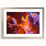 Textured abstract art print of Arizona's Antelope Canyon in silver frame, featuring rich earth tones, ideal for bedroom art.