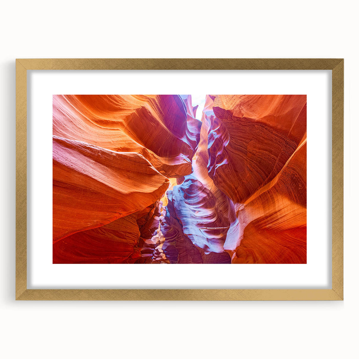 Extra large abstract art print of the Grand Canyon in vibrant orange and red tones on a gold-framed canvas.