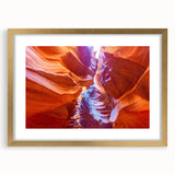 Extra large abstract art print of the Grand Canyon in vibrant orange and red tones on a gold-framed canvas.
