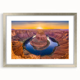 Textured art print of Horseshoe Bend in Arizona with muted earth tones, framed in silver, ideal for bedroom decor.