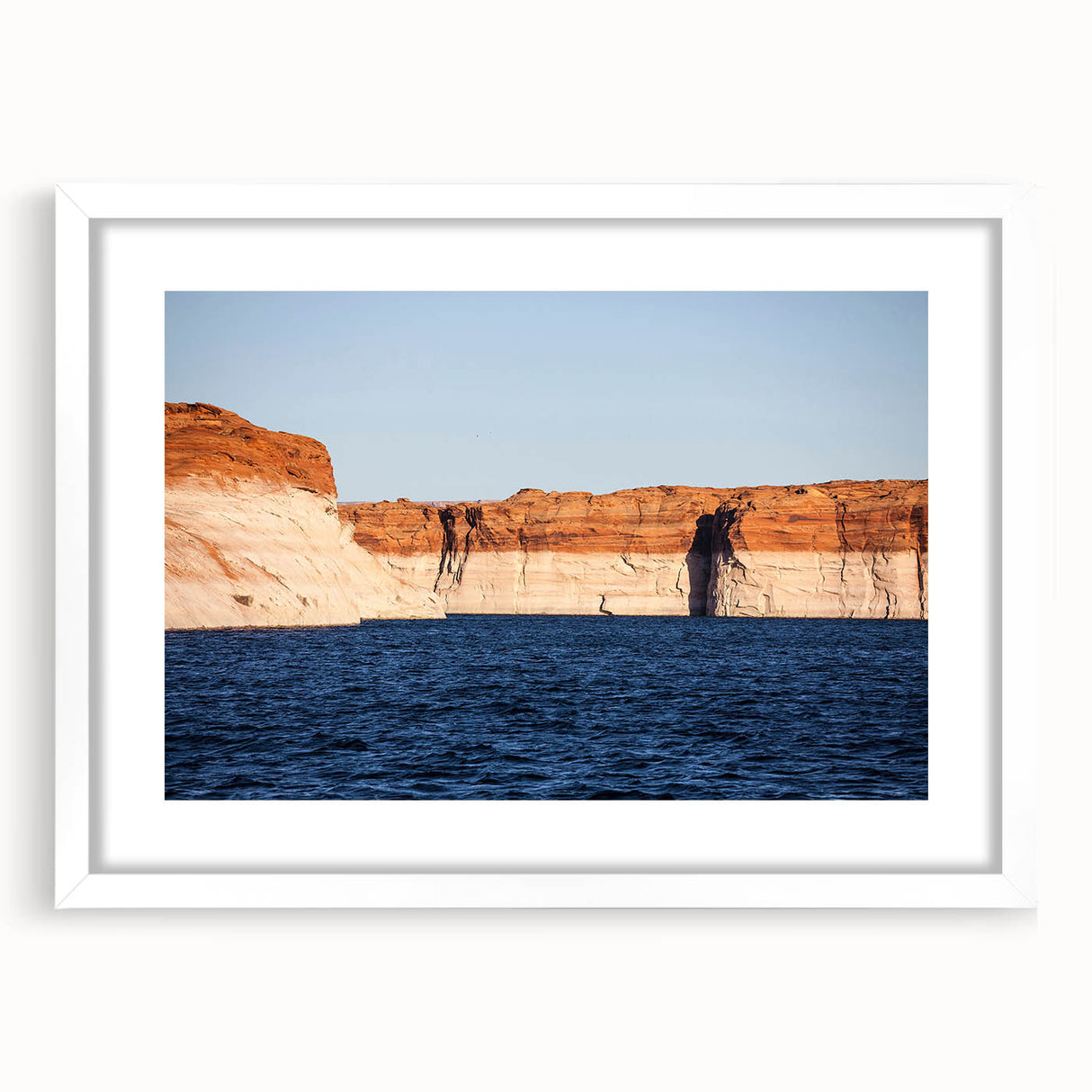 Abstract art print of Lake Powell in muted blue and beige tones on a white framed canvas.