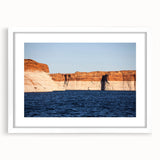 Abstract art print of Lake Powell in muted blue and beige tones on a white framed canvas.