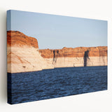 Large wall art of Lake Powell, Arizona, featuring vibrant blue and orange hues on stretched canvas.