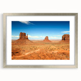 Textured art print of Monument Valley in muted earth tones on a framed canvas, suitable for bedroom decor.