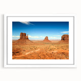 Abstract art print of Monument Valley in muted earth tones, framed with a white mat, suitable for dining room decor.