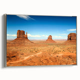 Framed canvas landscape art painting featuring Monument Valley in Arizona with vibrant red and orange tones.