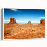 Vintage poster art of Monument Valley in vibrant colors on a large framed canvas, suitable for living room decor.