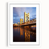 Abstract art print of Sacramento scenery in muted green and blue tones, framed with a white mat.
