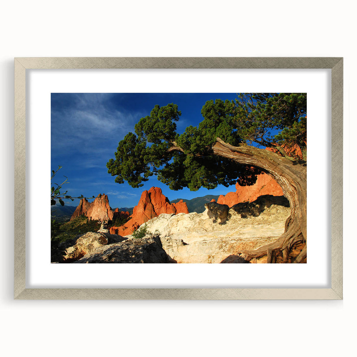 Textured art depicting abstract Colorado Springs scenery in muted earth tones on a framed silver mat.