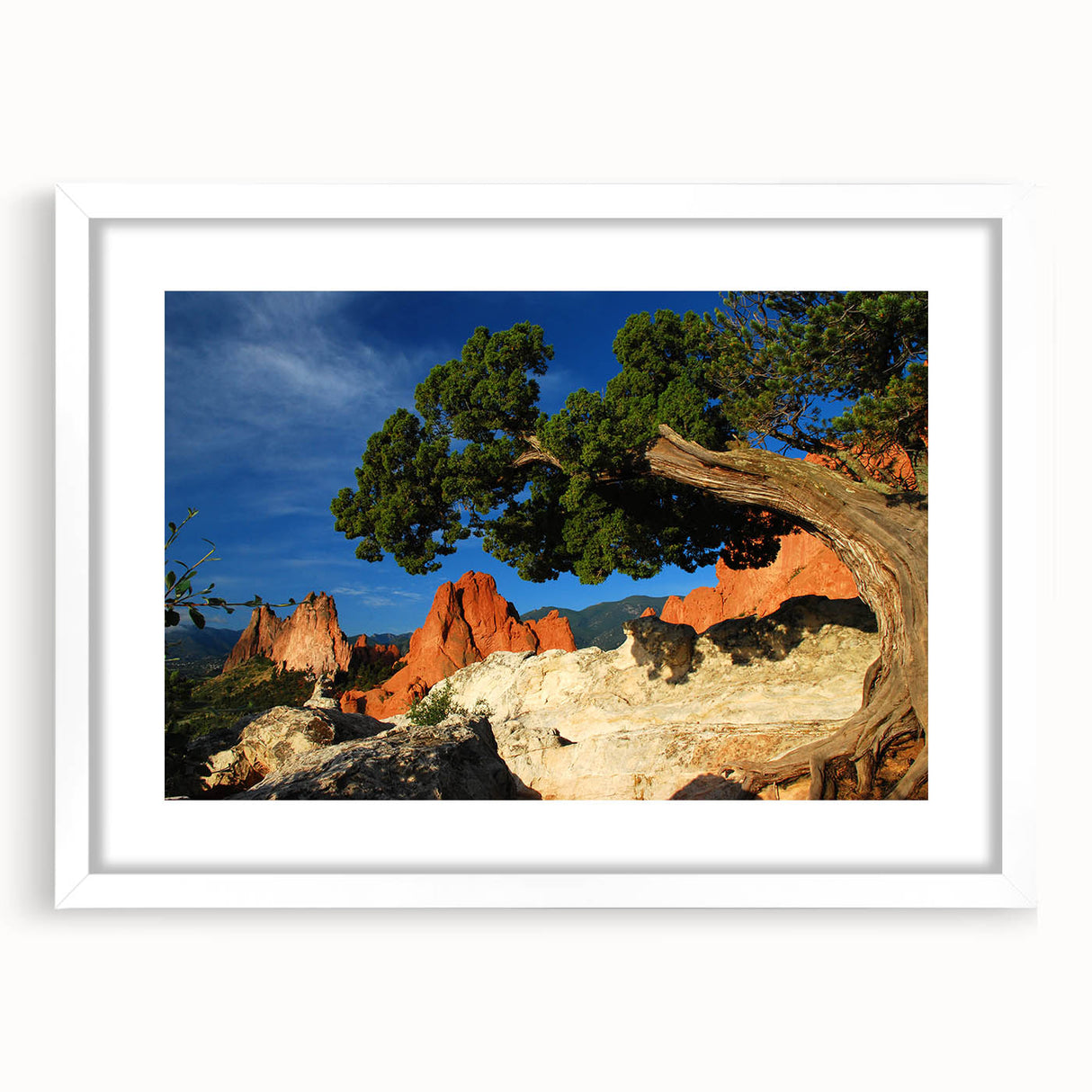 Abstract art print depicting Colorado Springs in muted earth tones on a framed white mat.