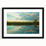 Extra large abstract art print of the Everglades in vibrant colors on a textured canvas, framed in black.