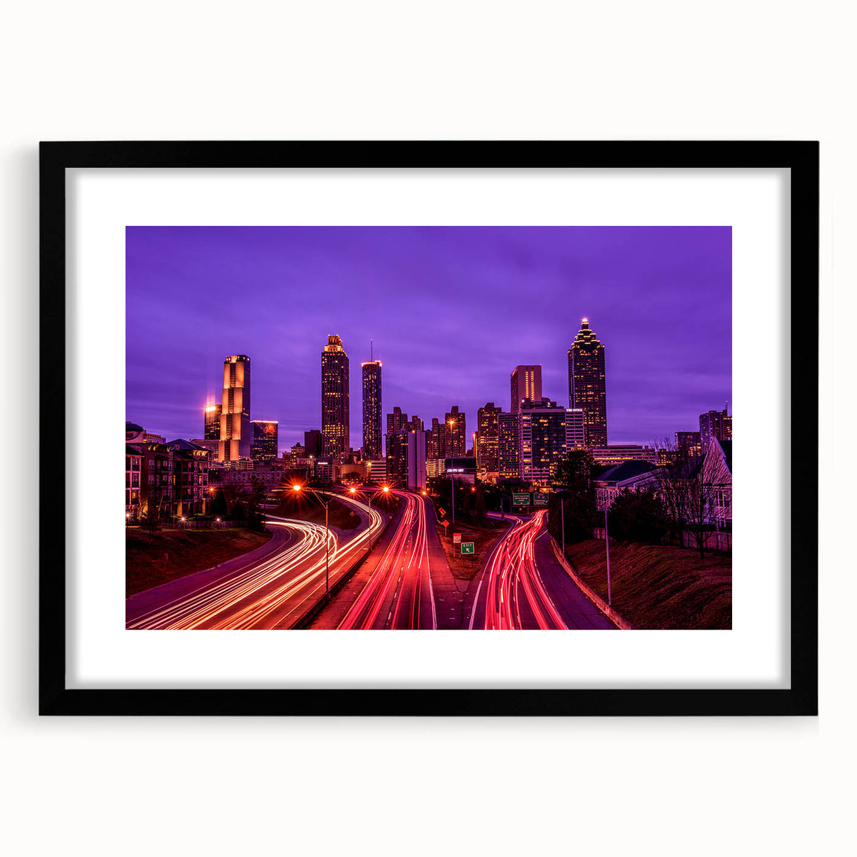 Abstract art print of Atlanta skyline in vibrant colors on a large framed canvas, ideal for living room decor.