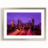 Textured abstract art print of Atlanta skyline in muted gray and blue tones, framed in silver.