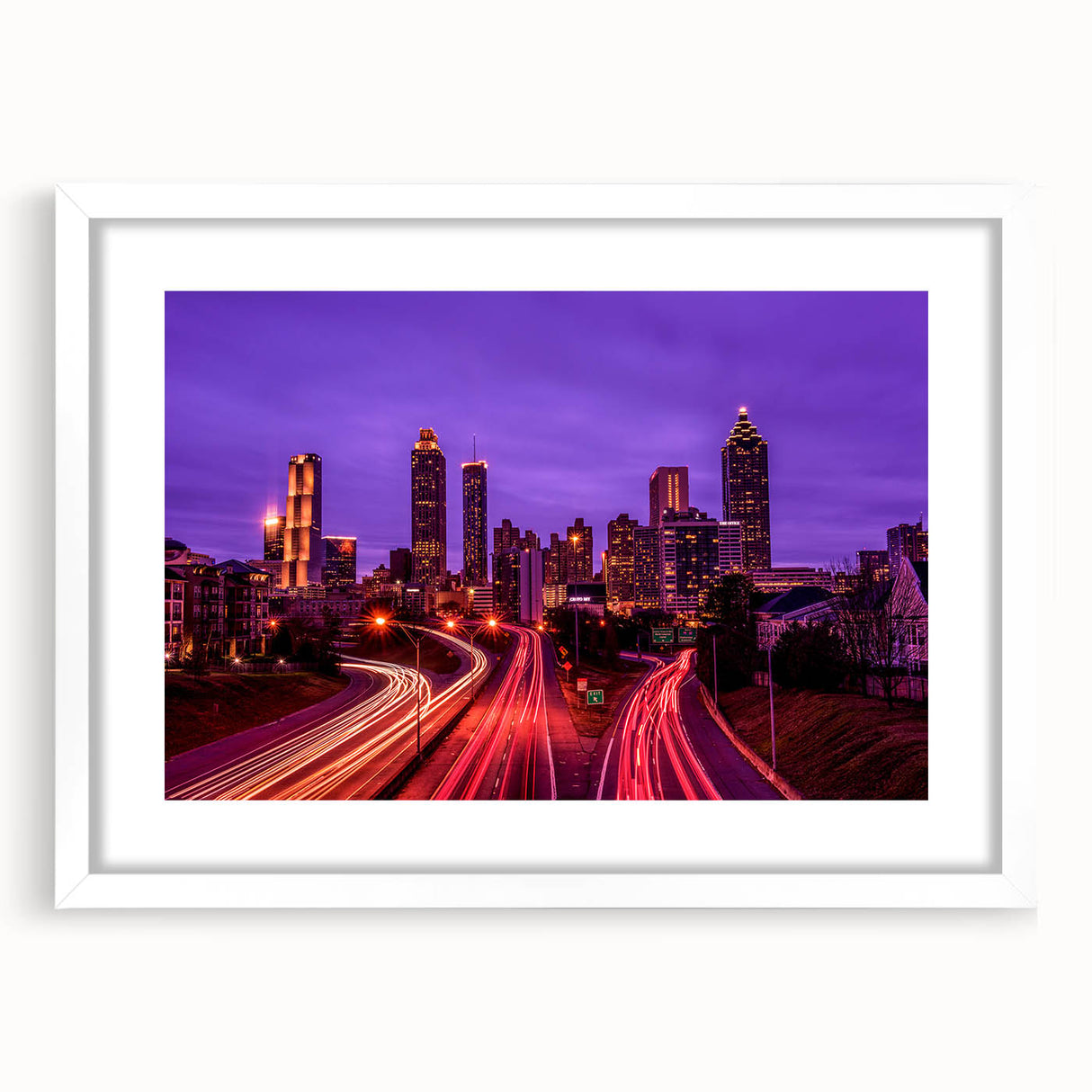 Abstract art print of Atlanta skyline in muted gray tones on a framed white mat, suitable for dining room decor.