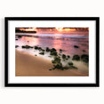 Colorful abstract art print of Hawaii's Kauai coastline in vibrant blues and greens, framed with a black mat.
