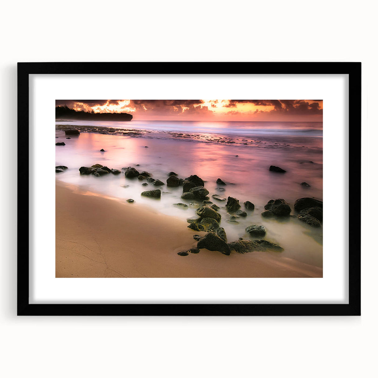 Colorful abstract art print of Hawaii's Kauai coastline in vibrant blues and greens, framed with a black mat.