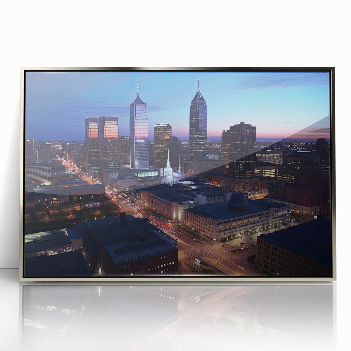 Mid-century modernist art depicting Indianapolis skyline in muted gray and blue tones, framed in silver acrylic.