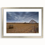 Textured abstract art print of Iowa scenery in muted earth tones, framed in silver, ideal for bedroom decor.