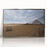 Mid-century modernist art depicting Iowa scenery in muted earth tones on a silver-framed acrylic print.