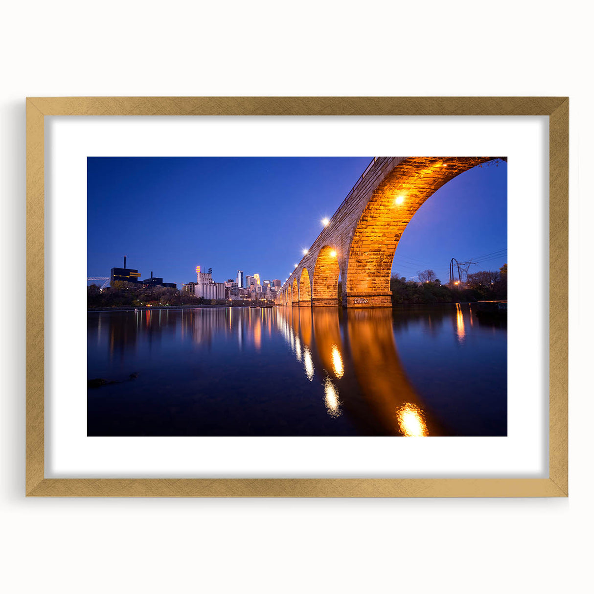 Textured art print of abstract Minneapolis skyline in muted gold and gray tones on a framed canvas.