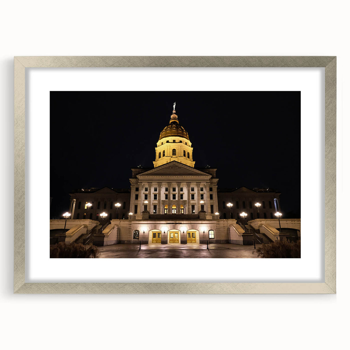 Textured art print of Kansas City skyline in muted gray tones on a framed silver mat, suitable for modern bedroom decor.