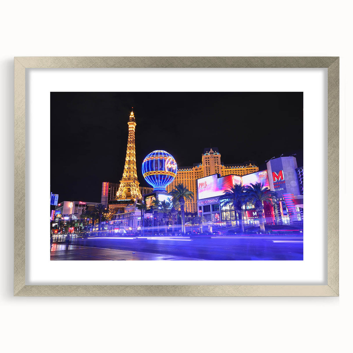 Textured art print depicting abstract Las Vegas skyline in muted silver and gray tones, framed with a silver mat.