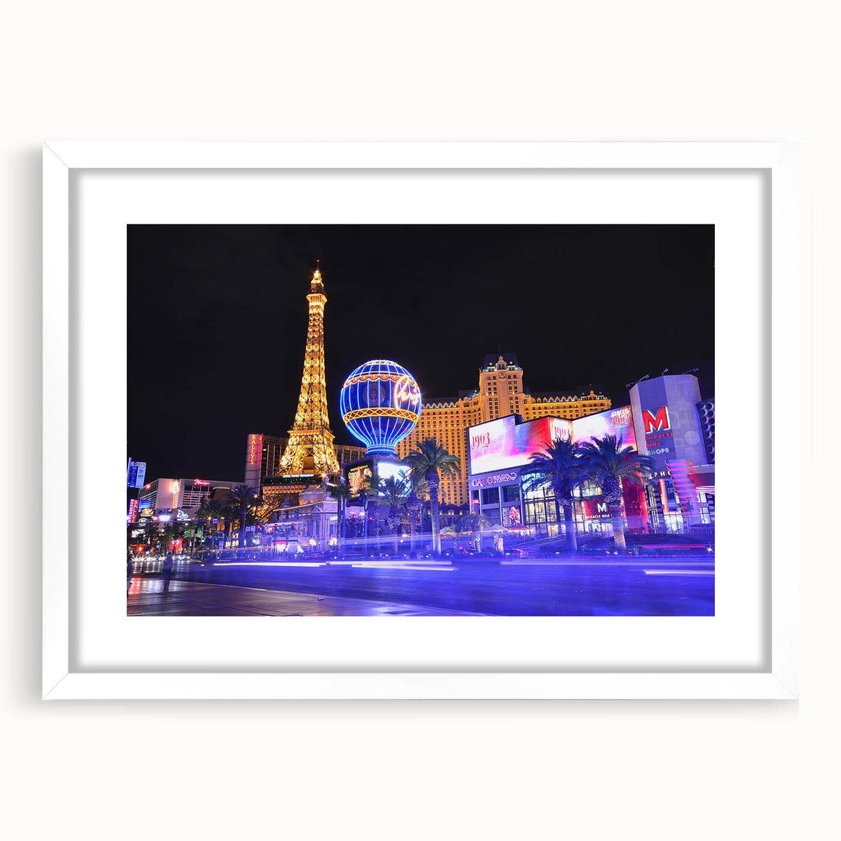 Abstract art print of the Las Vegas skyline in vibrant neon colors on a framed white mat, ideal for dining room decor.