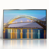 Mid-century modernist art depicting the New Jersey skyline, in muted blues and grays, framed in silver acrylic.