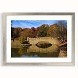 Textured abstract art print of Charlotte skyline in muted blue and gray, framed in silver, ideal for bedroom decor.