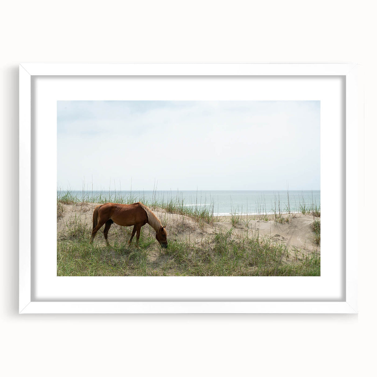Abstract art print of the Outer Banks with soft blue and gray tones on a white framed canvas.