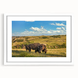Abstract art print of North Dakota scenery in muted earth tones, framed with a white mat, suitable for dining room decor.