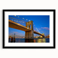 Colorful abstract art print of the Brooklyn Bridge in vibrant hues on a large framed canvas, ideal for living room decor.