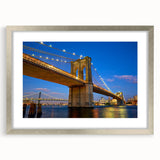 Textured art print of the Brooklyn Bridge in muted gray tones on a framed silver canvas, suitable for bedroom decor.