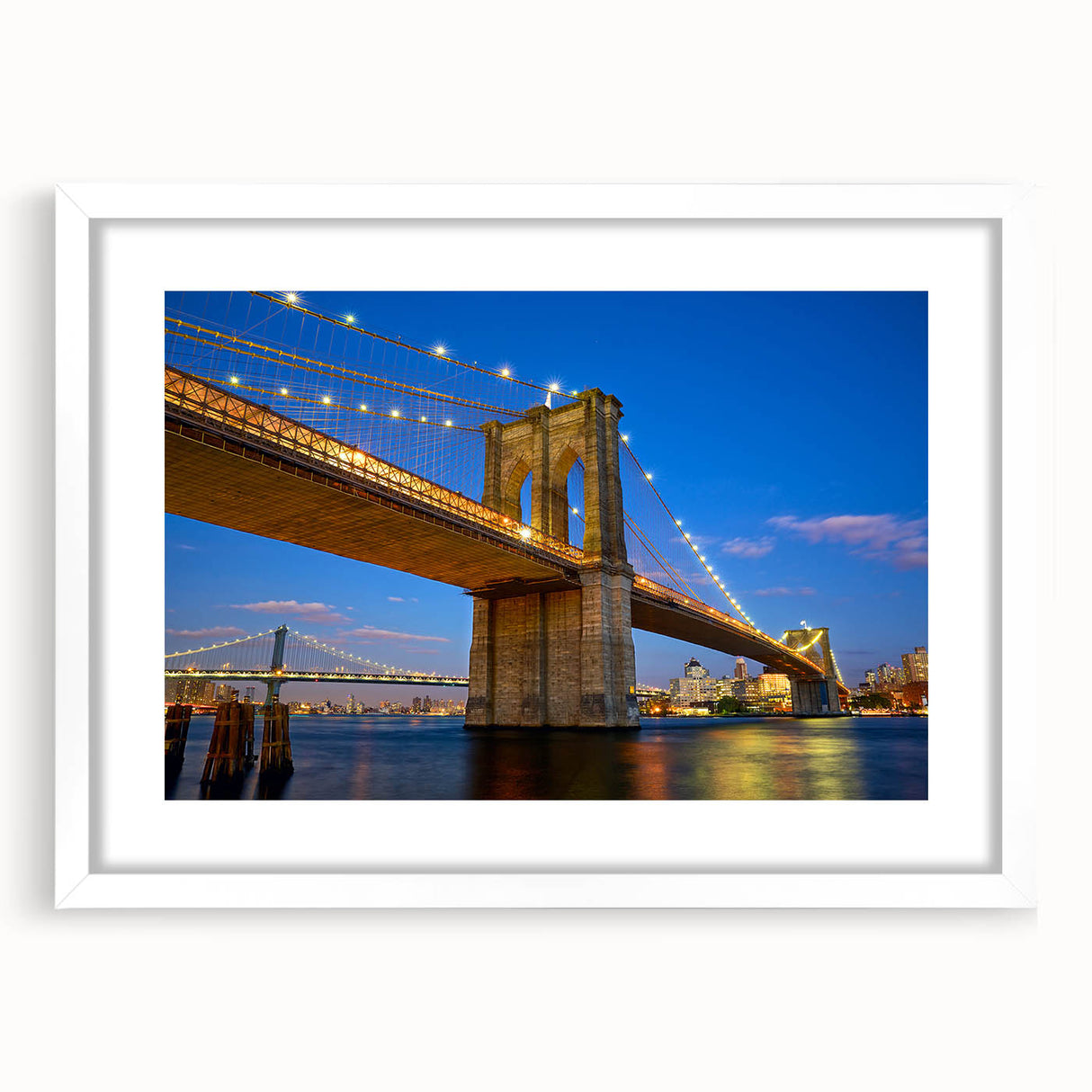 Abstract art print of the Brooklyn Bridge in muted gray and blue tones, framed with a white mat.