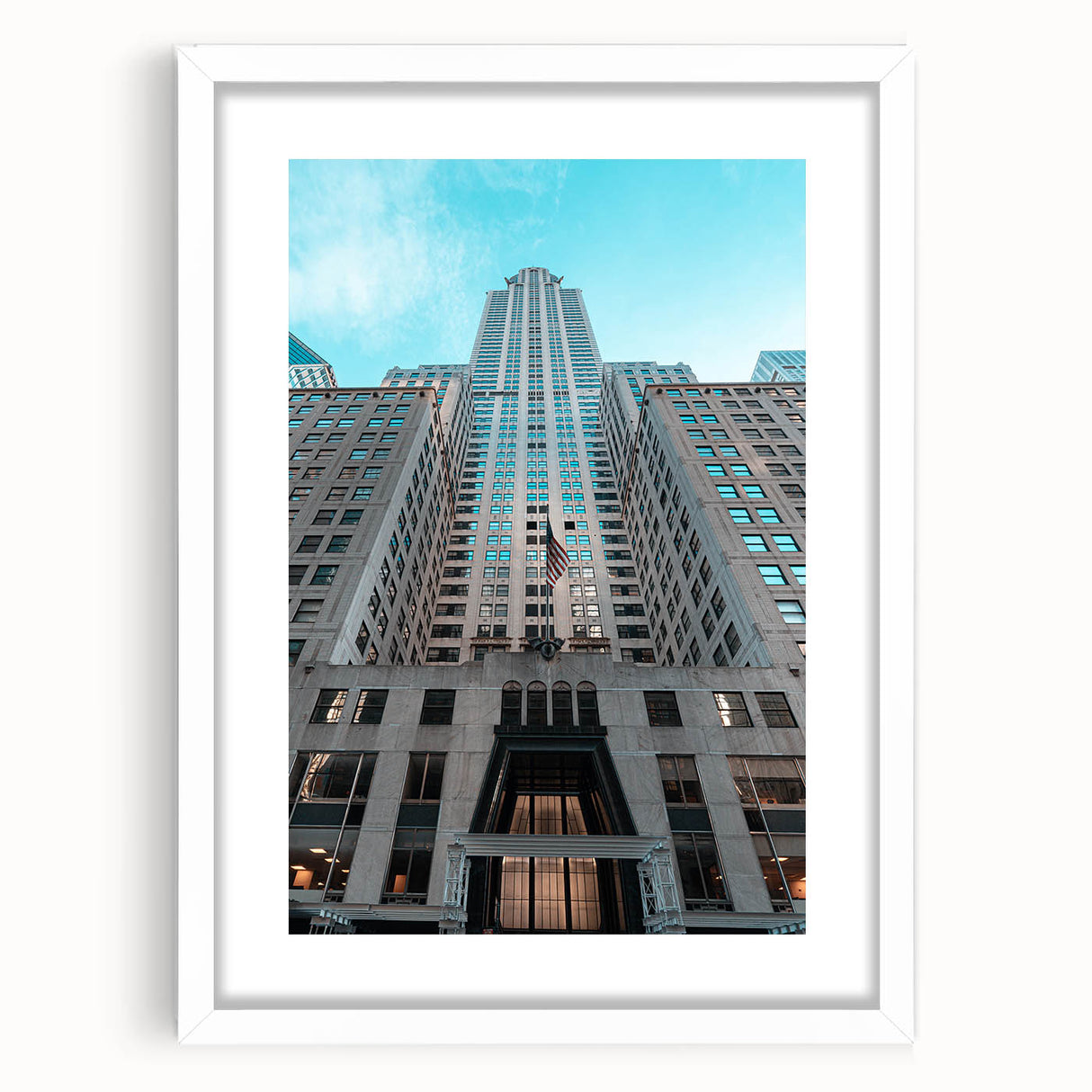 Abstract art print of the Chrysler Building in grayscale tones, framed in white, suitable for bedroom or dining room decor.