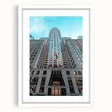 Abstract art print of the Chrysler Building in grayscale tones, framed in white, suitable for bedroom or dining room decor.