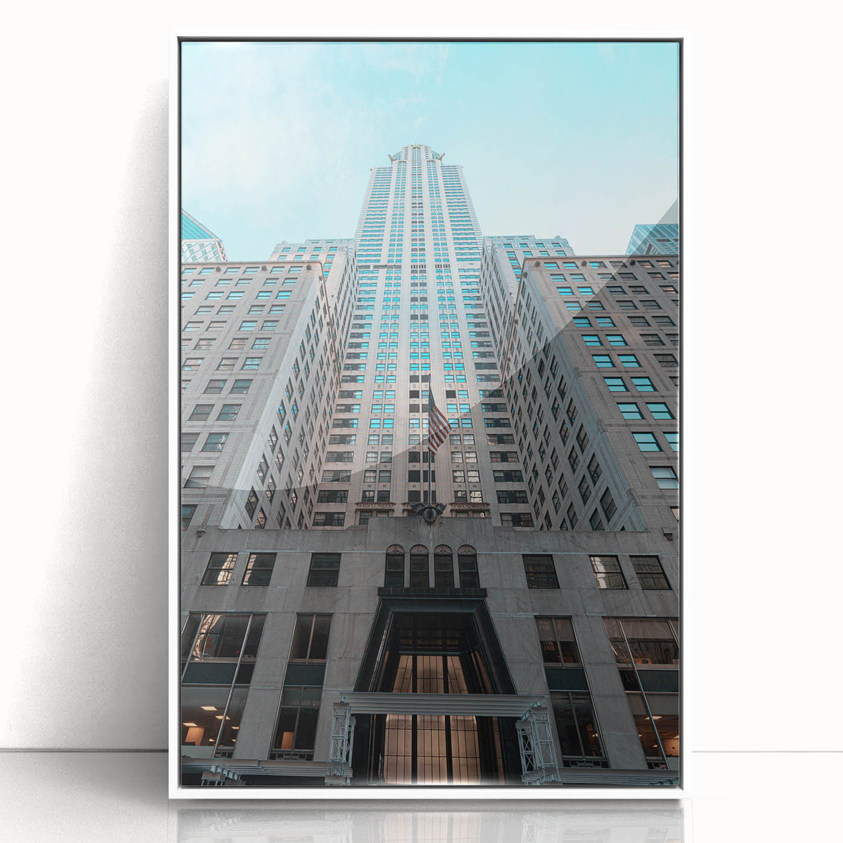 Art deco poster of the Chrysler Building in muted gray tones on a white framed acrylic, suitable for modern art wall decor.