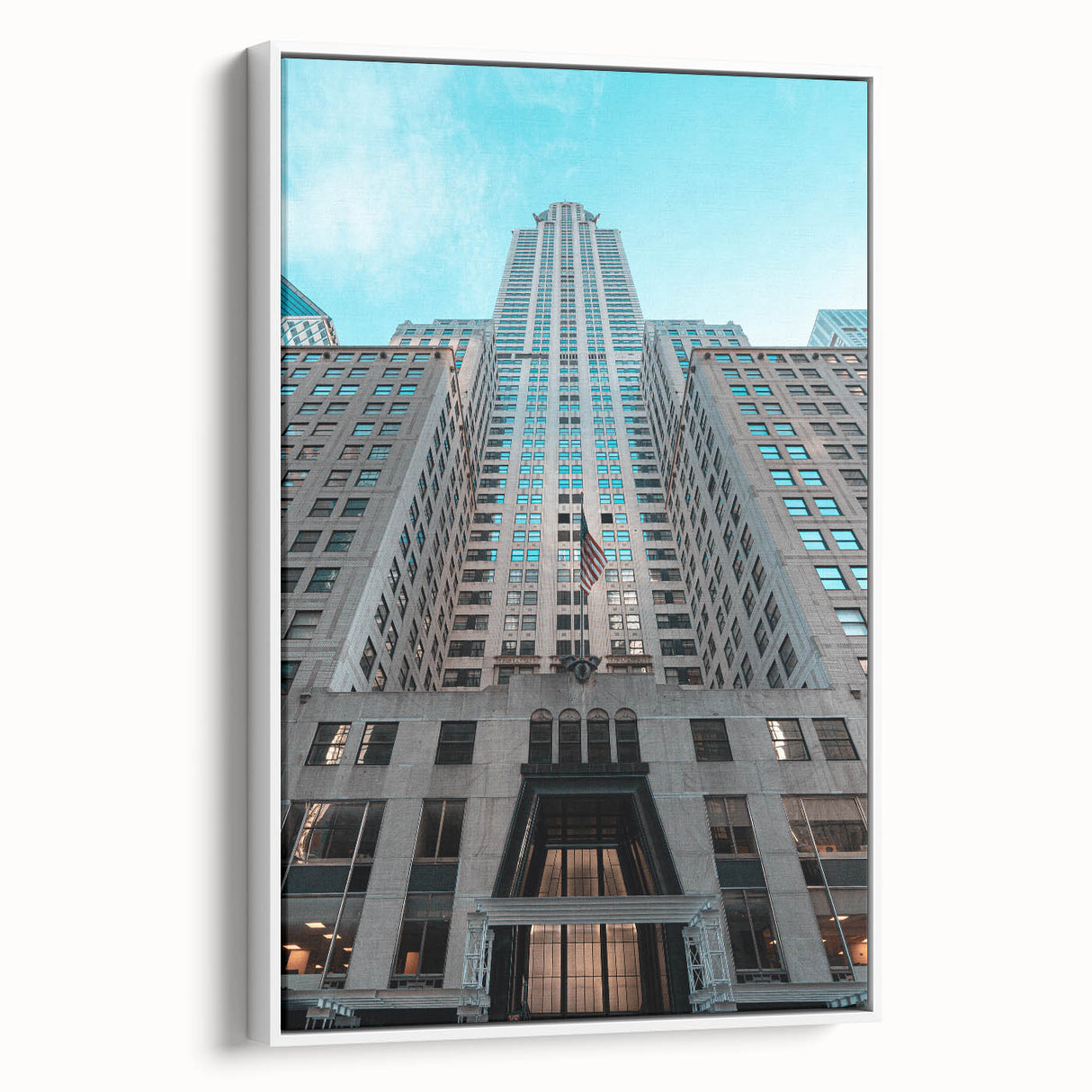 Vintage poster art of the Chrysler Building on a framed canvas, featuring black and colorful art.