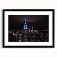 Extra large abstract art print of colorful New York City skyline, textured appearance, framed in black.