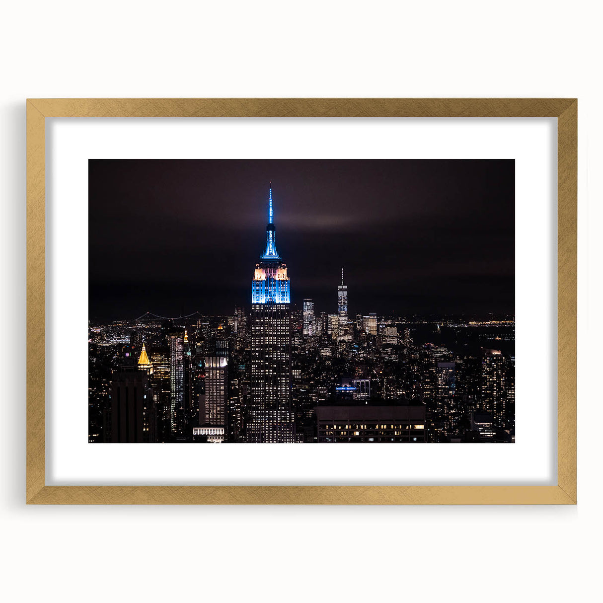 Extra large abstract art print of NYC's Empire State Building in textured gold hues on a framed canvas.
