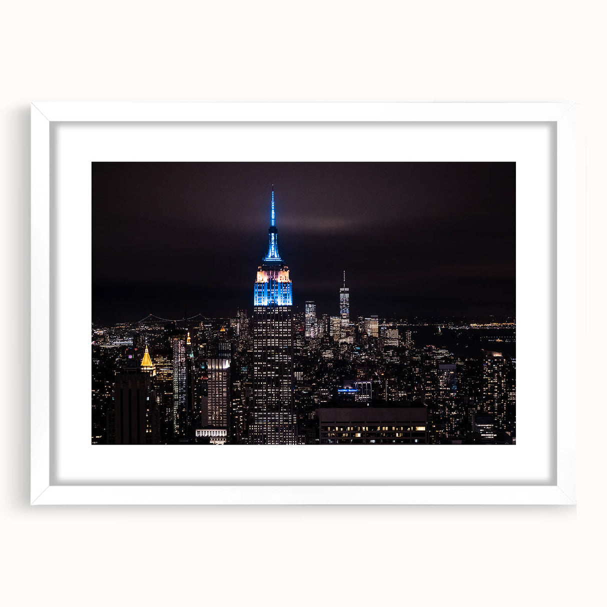 Abstract art print of NYC Empire State Building in muted gray tones on a framed white mat.