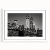 Abstract art print of Manhattan skyline in muted gray and blue tones on a framed white mat, ideal for dining room decor.