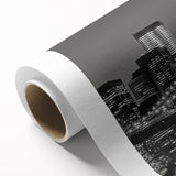 Art Deco style poster of Manhattan skyline in muted gray on rolled canvas.