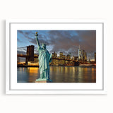 Abstract art print of the Statue of Liberty in muted blue and green tones on a white framed canvas.