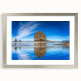 Textured art print of Cannon Beach, Oregon, in muted earth tones on a framed canvas, suitable for bedroom decor.