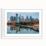 Abstract art print of Philadelphia skyline in muted blue and gray tones on a framed white mat, ideal for dining room decor.