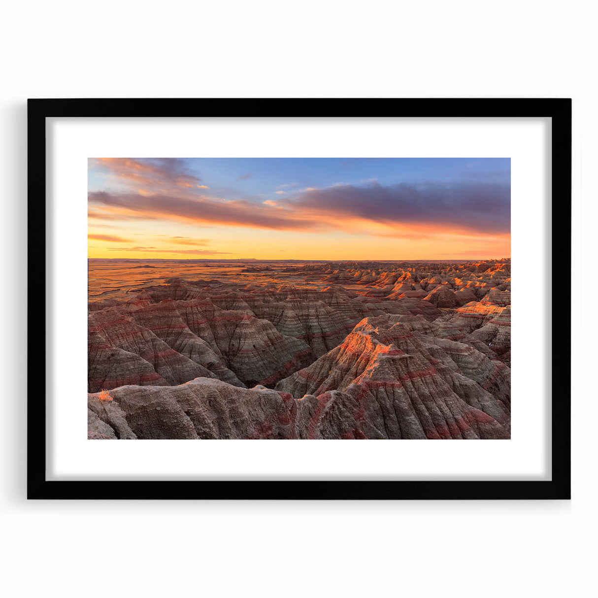 Abstract art print of South Dakota Badlands in vibrant colors on a large framed canvas, suitable for living room decor.