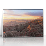 Acrylic print of South Dakota Badlands in muted earth tones, framed in white, suitable for modern art wall decor.