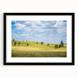 Abstract art print of South Dakota scenery in vibrant colors on a large framed canvas, suitable for living room decor.