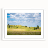 Abstract art print of South Dakota scenery in muted earth tones on a white framed canvas, suitable for dining room decor.
